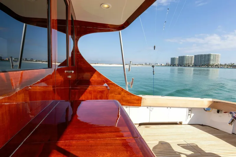 Slide: The Image of Luxurious 2004 Custom Ebony Sportfish 65' yacht with polished wood deck, ocean view. - 39