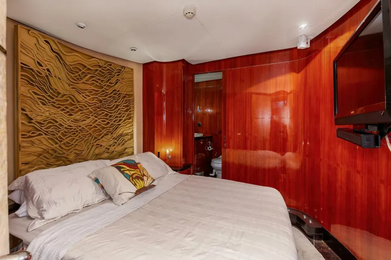 Slide: The Image of Luxurious bedroom in 2004 Custom Ebony Sportfish 65' CNV yacht with wood paneling and modern decor. - 4