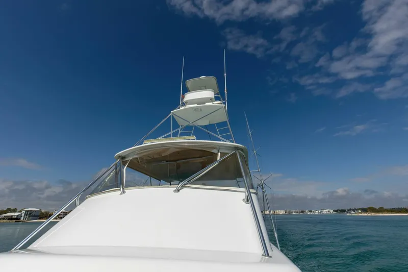 Slide: The Image of Custom Ebony Sportfish 65' CNV yacht, 2004 model, cruising under clear blue skies. - 46