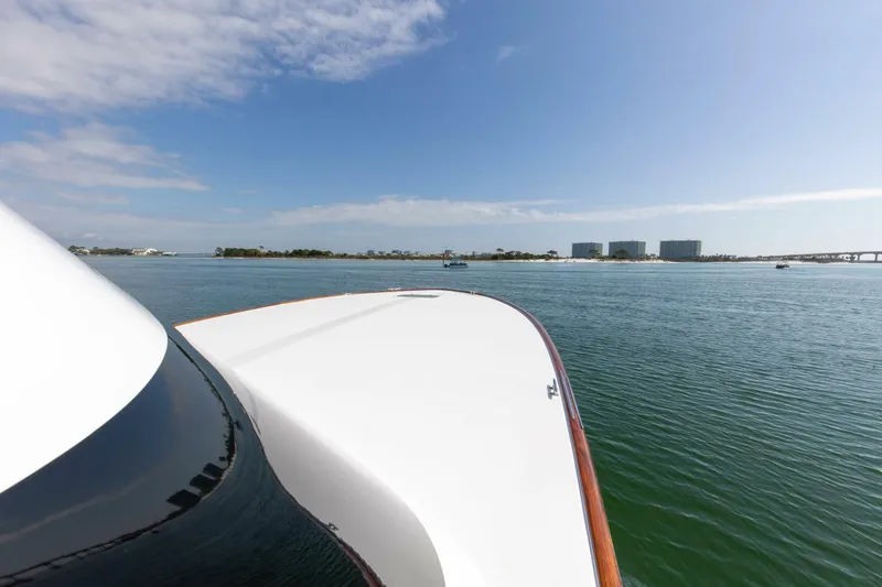Slide: The Image of Custom Ebony Sportfish 65' CNV yacht on calm waters, 2004 model, scenic view. - 47