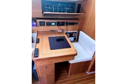 Slide: The Image of 2016 Catalina 445 yacht navigation station with control panels and seating. - 17