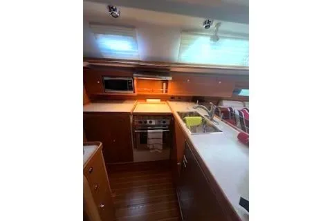 Slide: The Image of 2016 Catalina 445 yacht kitchen with modern appliances and wooden cabinetry. - 24