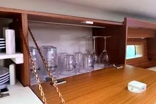 Slide: The Image of Cabinet interior of 2016 Catalina 445 yacht with glassware and plates. - 30