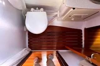 Slide: The Image of Aft of the main salon head with electric toilet, vanity, cabinet and upgraded teak flooring. - 39