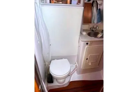 Slide: The Image of 2016 Catalina 445 yacht head with toilet, sink, and teak flooring. - 40