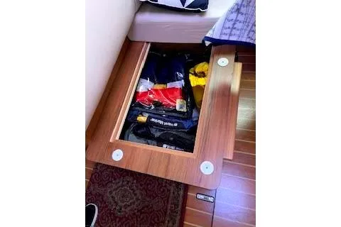 Slide: The Image of Under-seat storage compartment in 2016 Catalina 445 sailboat, containing various items. - 42