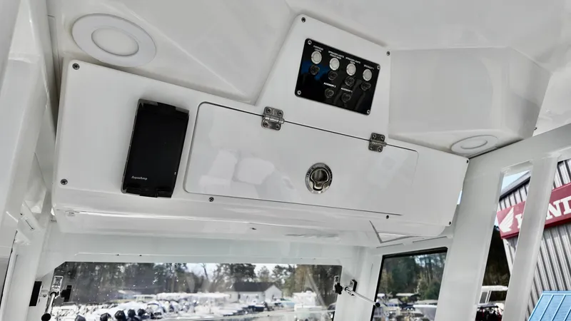 Slide: The Image of 2025 Sea Fox 268 Commander boat interior with control panel and storage compartment. - 10