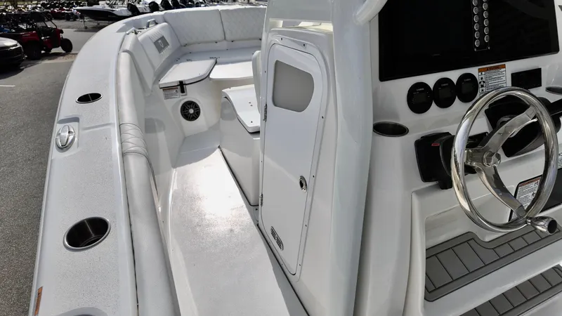 Slide: The Image of 2025 Sea Fox 268 Commander boat interior with steering wheel and seating area. - 11