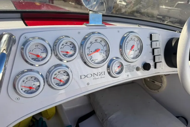 Slide: The Image of Dashboard of a 2001 Donzi 16 Classic boat with gauges and controls. - 10