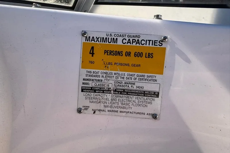 Slide: The Image of U.S. Coast Guard capacity label on 2001 Donzi 16 Classic boat, 4 persons or 600 lbs. - 14