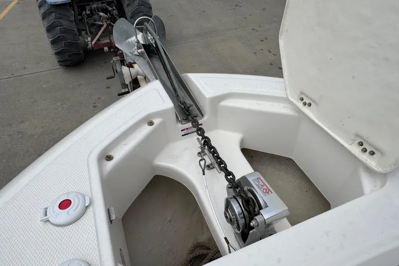 Slide: The Image of 2021 Robalo R242 Explorer boat anchor compartment with chain and winch system. - 11