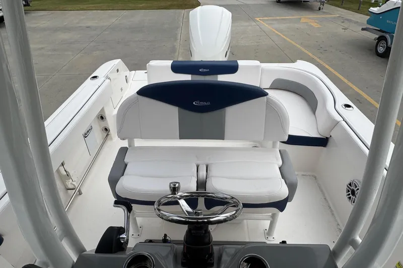 Slide: The Image of 2021 Robalo R242 Explorer boat interior with steering wheel and seating area. - 13