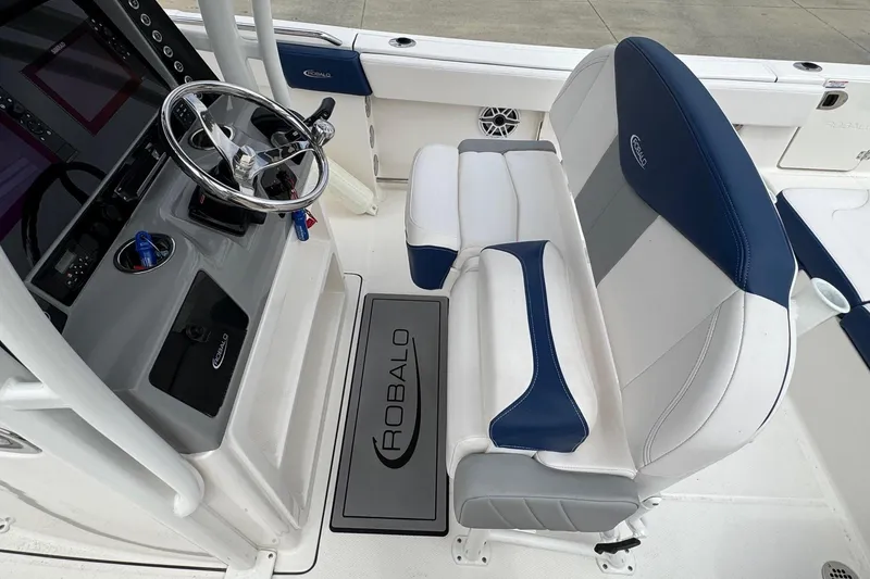 Slide: The Image of 2021 Robalo R242 Explorer helm with steering wheel and cushioned seating. - 14