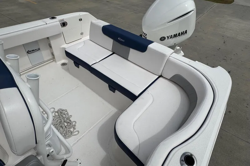 Slide: The Image of 2021 Robalo R242 Explorer boat interior with Yamaha engine, featuring white and blue seating. - 17
