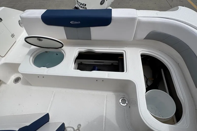 Slide: The Image of 2021 Robalo R242 Explorer boat interior with storage compartments and seating. - 18