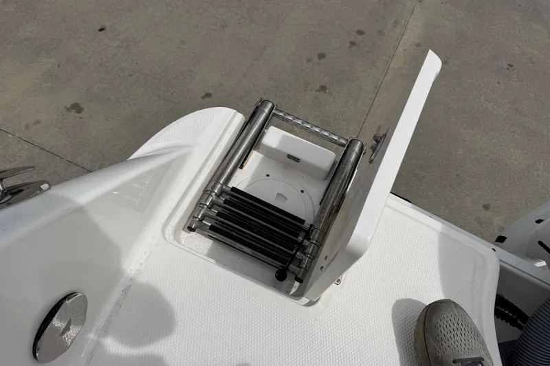 Slide: The Image of 2021 Robalo R242 Explorer boat ladder compartment, open on deck. - 20