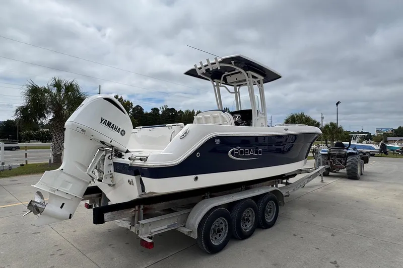 Slide: The Image of 2021 Robalo R242 Explorer boat on trailer with Yamaha engine, parked outdoors. - 5