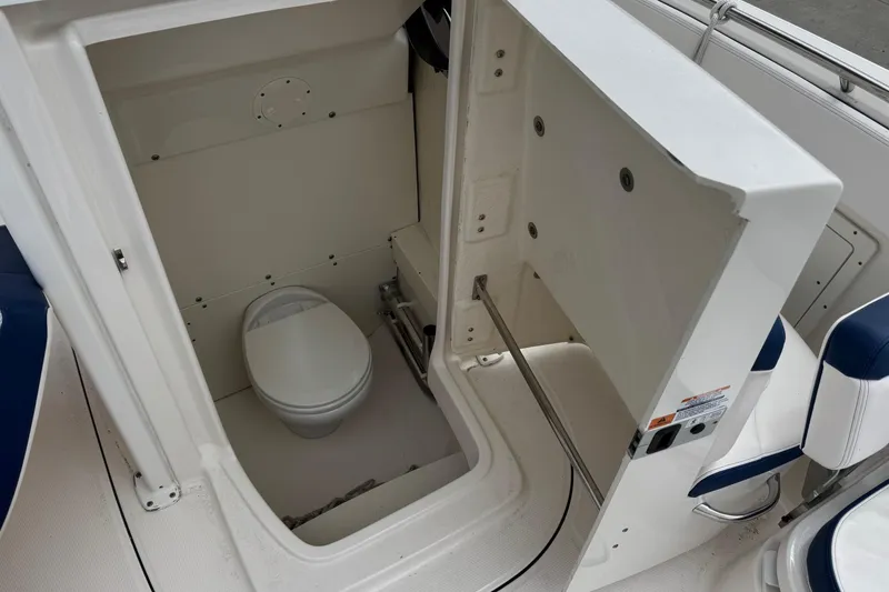 Slide: The Image of 2021 Robalo R242 Explorer boat interior with compact marine toilet. - 7