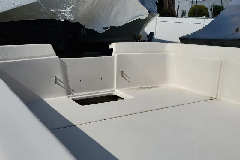 Slide: The Image of 2024 Carolina Skiff E24DLX Kit boat interior with open storage compartment. - 4
