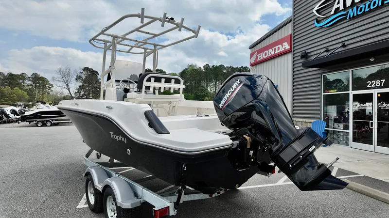Slide: The Image of 2025 Bayliner Trophy 20 boat on trailer, parked outside dealership. - 11
