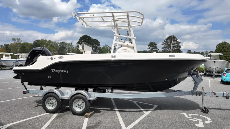 Slide: The Image of 2025 Bayliner Trophy 20 boat on trailer in parking lot, under cloudy sky. - 13