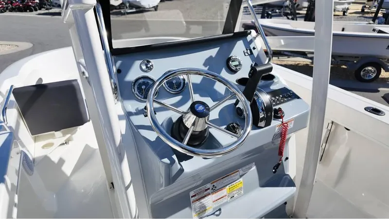 Slide: The Image of 2025 Bayliner Trophy 20 boat dashboard with steering wheel and control panel. - 3