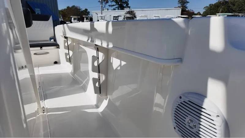 Slide: The Image of 2025 Bayliner Trophy 20 boat interior with rod holders and speaker. - 7