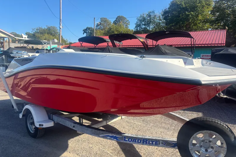 Slide: The Image of 2026 Starcraft SV 16 OB boat with red hull on a LoadRite trailer. - 11