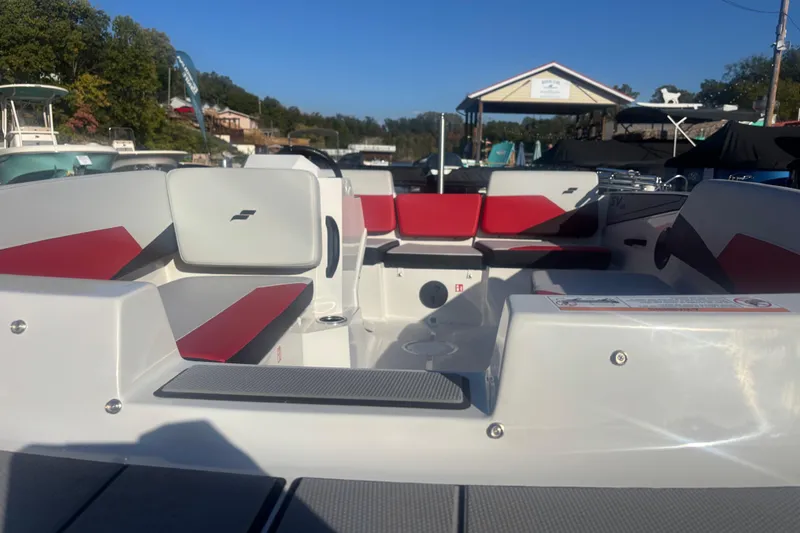 Slide: The Image of 2026 Starcraft SV 16 OB boat interior with red and white seating, docked outdoors. - 4