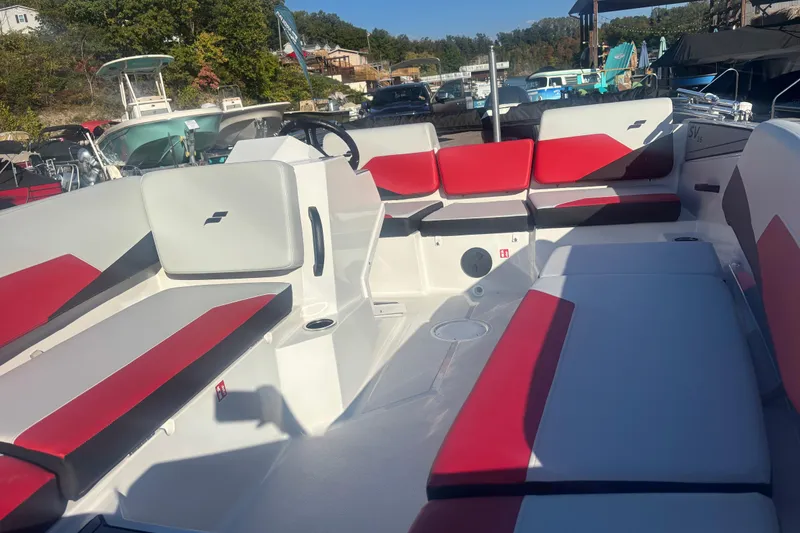 Slide: The Image of 2026 Starcraft SV 16 OB boat interior with red and white seating, docked outdoors. - 5