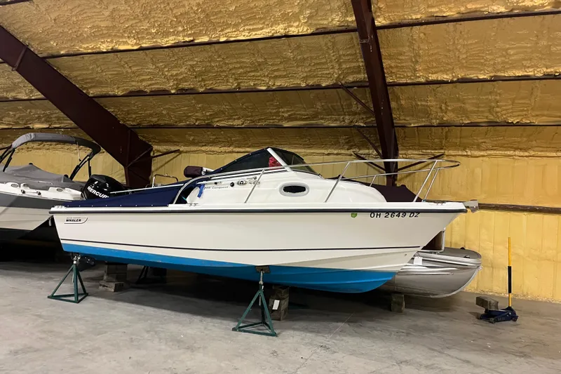 The Image of 2006 Boston Whaler 205 Conquest boat in indoor storage on stands. - 0