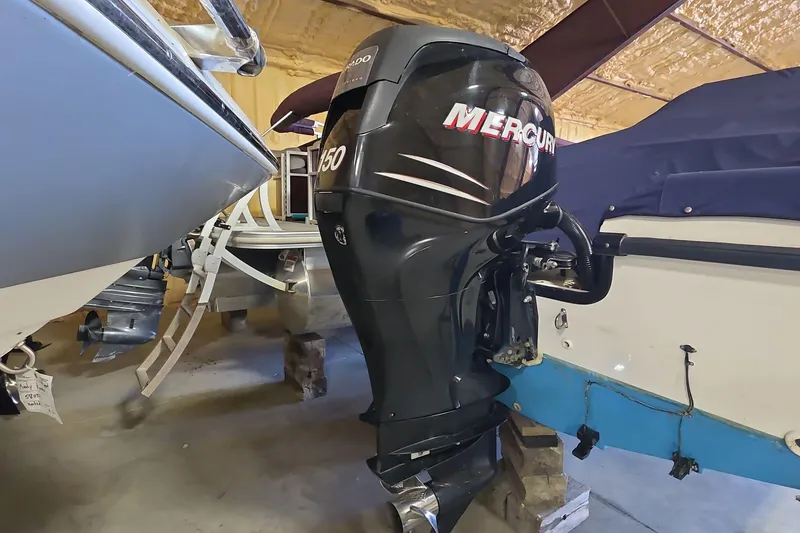 Slide: The Image of 2006 Boston Whaler 205 Conquest with Mercury 150 outboard engine in storage. - 14