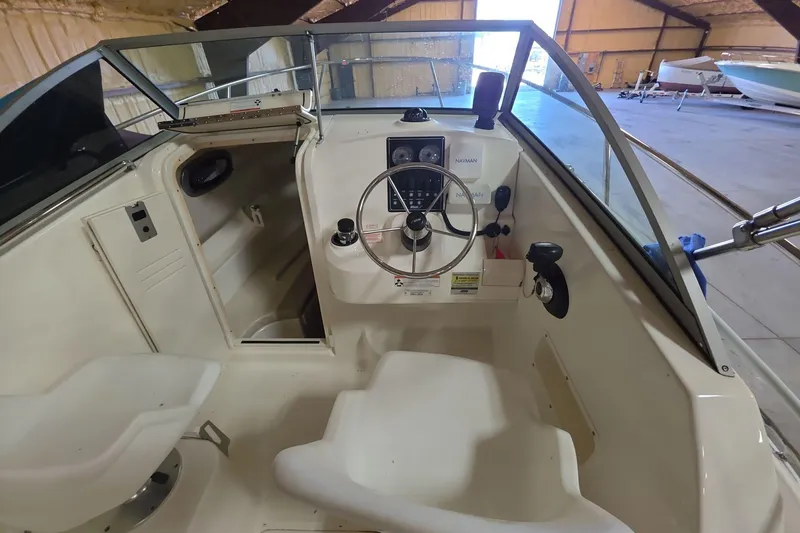 Slide: The Image of 2006 Boston Whaler 205 Conquest boat interior with steering wheel and control panel. - 16