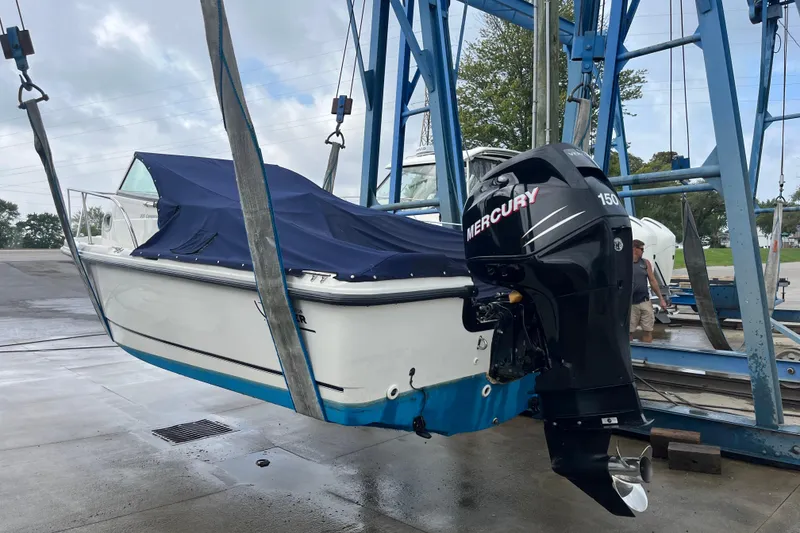 Slide: The Image of 2006 Boston Whaler 205 Conquest boat with Mercury 150 engine on lift. - 3