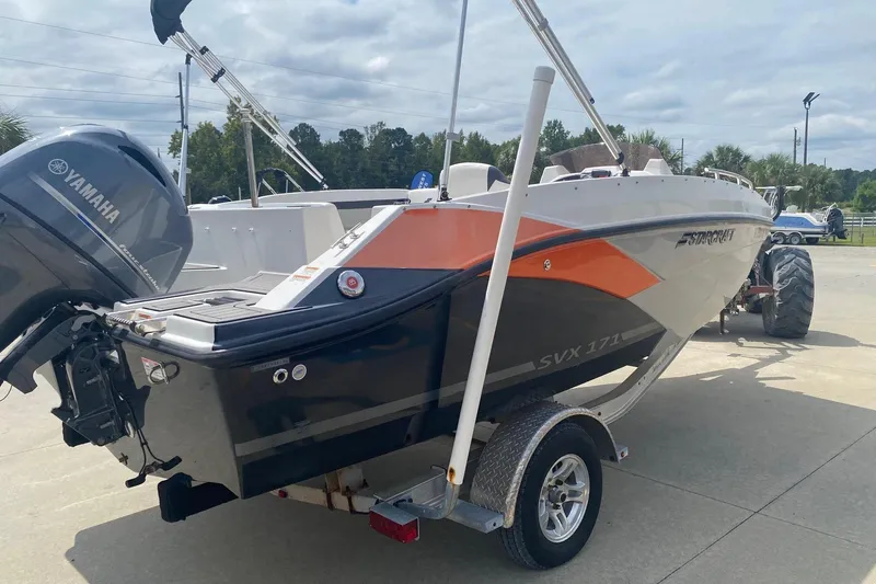 Slide: The Image of 2021 Starcraft SVX 171 OB boat with Yamaha engine on trailer, parked outdoors. - 3