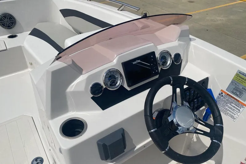 Slide: The Image of 2021 Starcraft SVX 171 OB boat dashboard with steering wheel and gauges. - 6