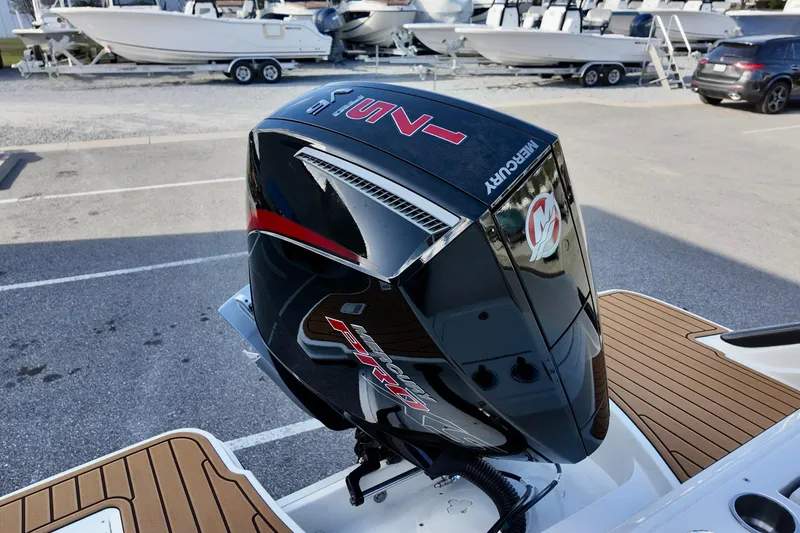 Slide: The Image of 2026 Bayliner Trophy T20CC with Mercury outboard engine, parked on a wooden deck. - 10