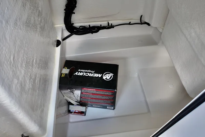 Slide: The Image of Storage compartment of 2026 Bayliner Trophy T20CC with Mercury propeller box. - 12