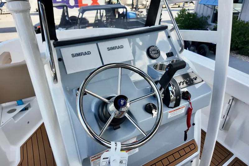 Slide: The Image of 2026 Bayliner Trophy T20CC boat helm with Simrad electronics and steering wheel. - 14