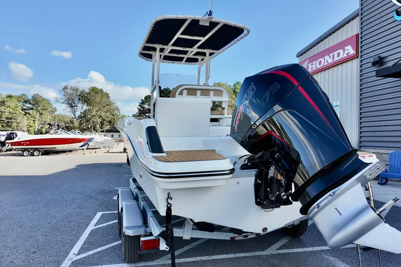 Slide: The Image of 2026 Bayliner Trophy T20CC boat with powerful outboard motor, parked on a trailer. - 4