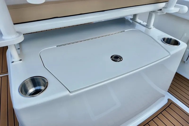 Slide: The Image of 2026 Bayliner Trophy T20CC boat deck with storage compartment and cup holders. - 7