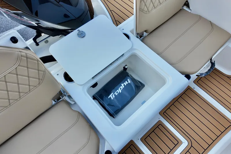 Slide: The Image of 2026 Bayliner Trophy T20CC boat interior with storage compartment and cushioned seats. - 8