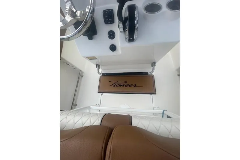Slide: The Image of 2022 Pioneer 202 Islander boat dashboard with steering wheel and controls. - 10