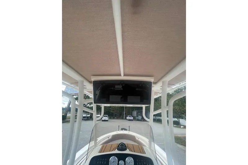 Slide: The Image of 2022 Pioneer 202 Islander boat console with canopy and dashboard view. - 11