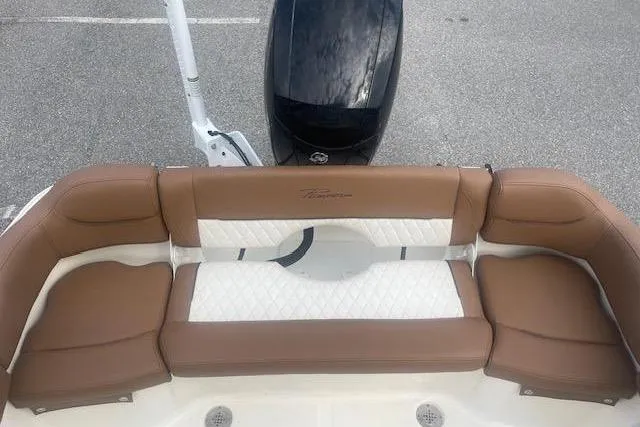 Slide: The Image of 2022 Pioneer 202 Islander boat with brown and white cushioned seating. - 12