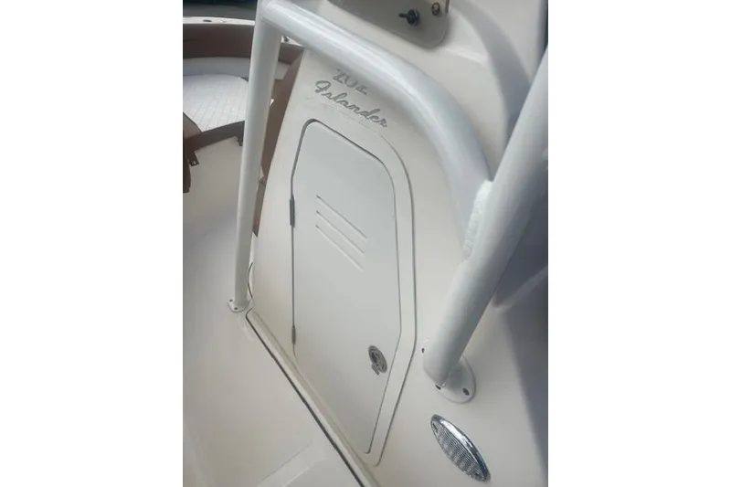 Slide: The Image of 2022 Pioneer 202 Islander boat interior with storage compartment and seating. - 16