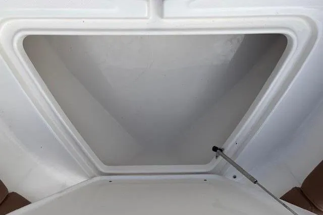 Slide: The Image of 2022 Pioneer 202 Islander boat storage compartment, open and empty, with hydraulic support. - 20