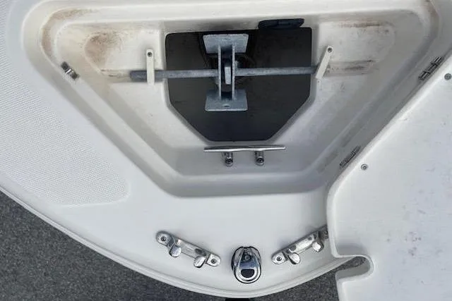 Slide: The Image of 2022 Pioneer 202 Islander boat anchor compartment with metal fittings and clean design. - 22