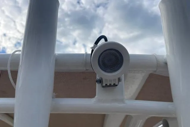 Slide: The Image of Close-up of a speaker on a 2022 Pioneer 202 Islander boat under a cloudy sky. - 23