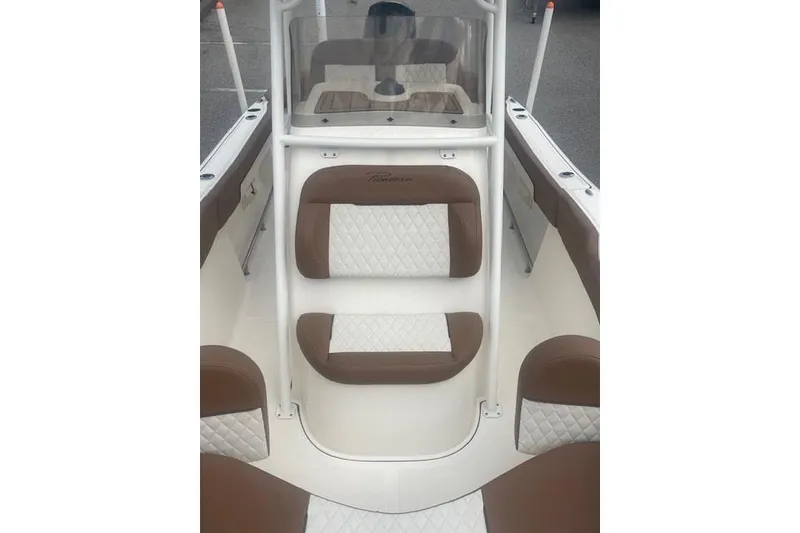 Slide: The Image of 2022 Pioneer 202 Islander boat interior with brown and white cushioned seating. - 5